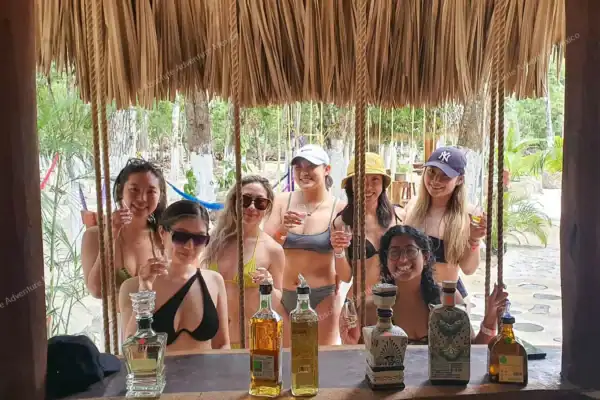 Group of girls in  swimsuits sipping tequila