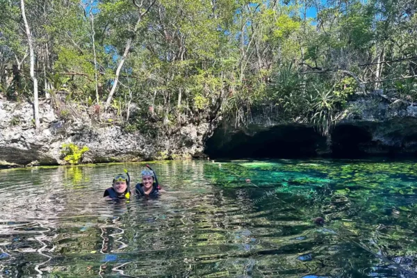 Swimming in open  cenote Nicte-Ha surrounded by jungle
