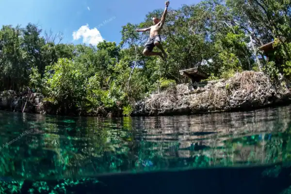 Cliff jumping at  Cenote Jaguar during private tour