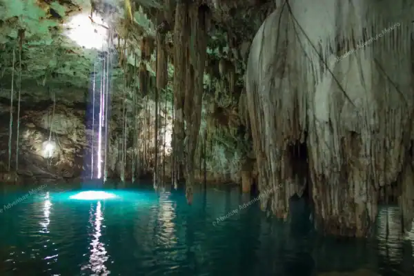 Cenote Xkekén with  stalactites and light