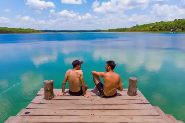 Two visitors  sitting on lagoon pier