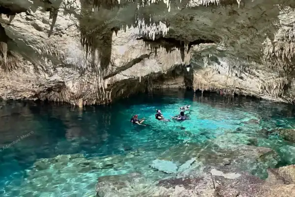 Tourists exploring Cenote Taak Bi Ha cave