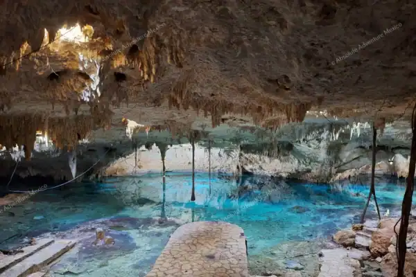 Swimming through  Cenote Taak Bi Ha cave