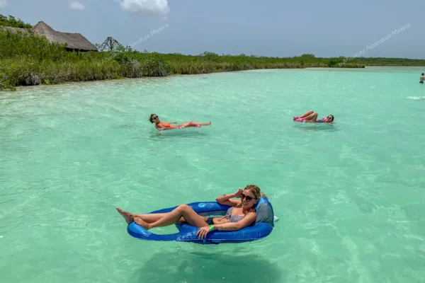 Girl floating in a  boat on Kaan Luum Lagoon