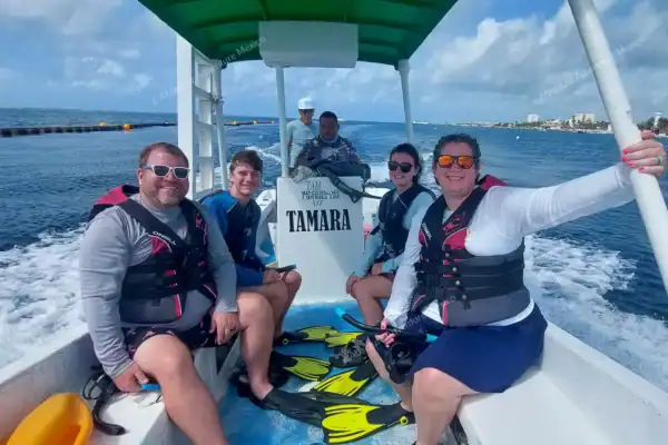 Four people riding  boat to reef snorkeling spot