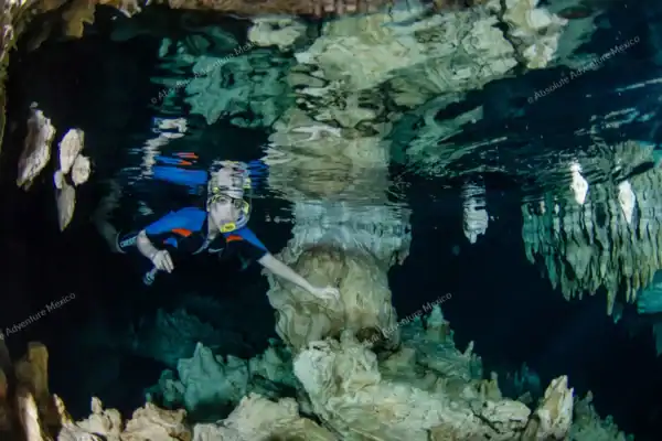 Snorkeler exploring  Cenote Pet Cemetery cave