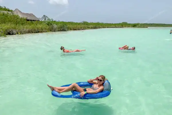 Guest relaxing on  floating buoy at Kaan Luum