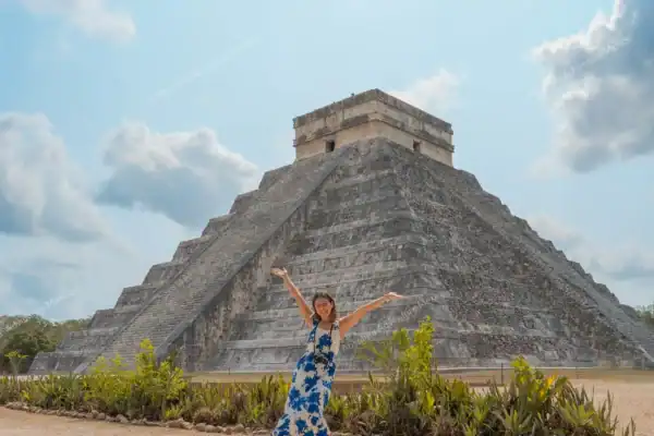 Girl in front of  Kukulkan pyramid on Chichen Itza and Ek Balam private tour
