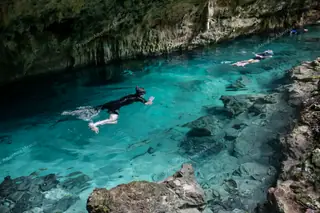 People snorkeling
  at Dos Ojos cenote tour