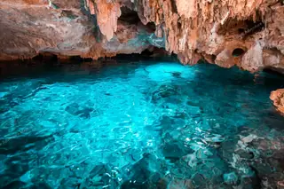 Transparent water
  and rock formations at Dos Ojos