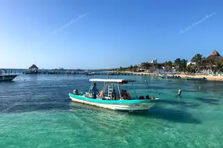 Snorkeling boat
  leaving the pier Puerto Morelos