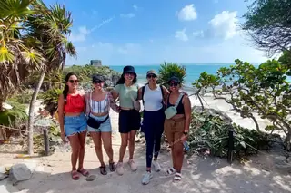 Group of girls
  visiting Tulum ruins on private tour