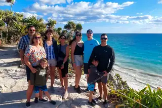 Happy group
  visiting Tulum ruins