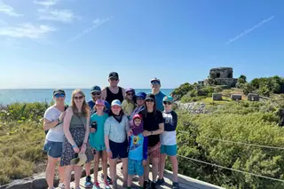 Family exploring
  Tulum archaeological site on private excursion