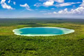 Wide aerial view of
  Kaan Luum Lagoon and jungle