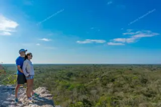 Couple on top of
  Nohoch Mul pyramid at Coba private tour