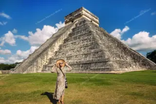 Lady posing in
  front of Chichen Itza pyramid during private tour