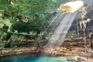 Cenote Samulá light
  beam through ceiling