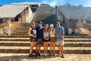 Family pausing in
  front of Ek Balam pyramid