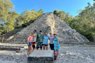 Family pausing in
  front of Nohoch Mul pyramid
