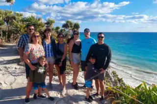 Happy group
  visiting Tulum ruins