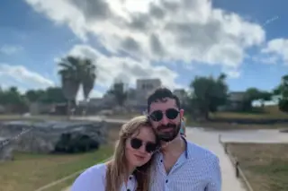 Happy couple with
  ruins in background