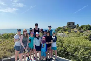 Happy family by
  cliff with Temple of the Wind and ocean