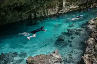 Swimming inside Dos
  Ojos cenote on Tulum boat tour